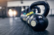 © peopleimages.com - Exercise, kettlebell and weights on floor of gym for training, wellness or workout with space. Background, metal equipment in health club and fitness for action, physical improvement or strength