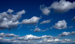 © Andrew - Fleecy clouds against blue sky.