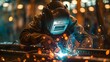 A worker in overalls welding in a workshop. Concept Industrial Work, Blue Collar, Welding, Workshop, Overalls