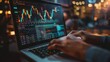 Trader Analyzing Stock Market Graphs on Laptop at Night