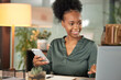 © peopleimages.com - Laptop, phone and smile with business black woman at desk in office for administration or research. Computer, communication and notebook with happy employee in professional workplace for networking