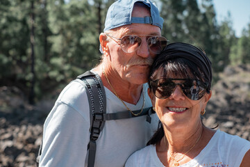 Sticker - Beautiful couple of old people enjoying travel in the mountain - smiling elderly man and woman appreciating adventure and freedom, healthy lifestyle concept