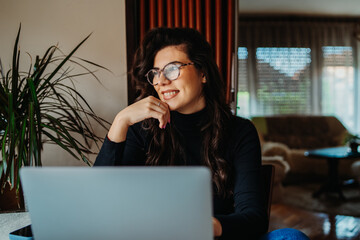 One young caucasian woman working on laptop from home