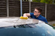 Man cleaning a car with microfiber. Car Detailing. Car Cosmetics