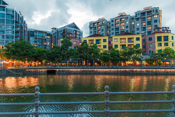 Wall Mural - General view from Singapore skyscrapers and flats among green streets during twilight