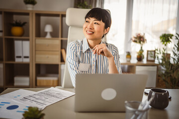 Wall Mural - Mature japanese woman sit and think at office positive