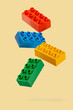 Building toy blocks on yellow background.