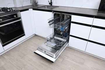 Sticker - Open clean empty dishwasher in kitchen. Home appliance