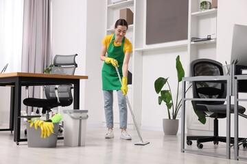 Canvas Print - Cleaning service worker washing floor with mop. Bucket with supplies in office