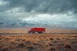 Red semi truck moving through desert road with mountains under cloudy sky