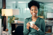© peopleimages.com - African woman, portrait and office with coffee, smile and confidence for career goals. Creative writer, professional news editor and expert reporter for content creation, publishing and press startup
