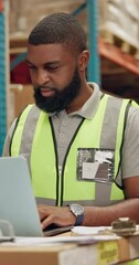 Canvas Print - African man, laptop and logistics in warehouse with distribution for supply chain, quality control or happy with online stock. Manufacturing, worker or inspection with digital checklist for inventory