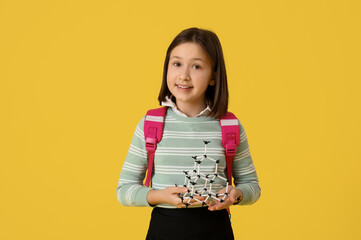 Sticker - Cute girl in school uniform with backpack on yellow background