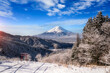 Red Japanese Torii pole, Fuji mountain and snow in Kawaguchiko, Japan. Forest trees nature landscape background in winter season.