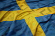 waving colorful national flag of sweden on a euro money banknotes background. finance concept.