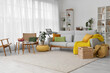 © Pixel-Shot - Interior of living room with grey sofa, armchair and shelf units