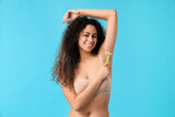 Fototapeta Tulipany - Beautiful young happy woman with razor on blue background. Depilation concept