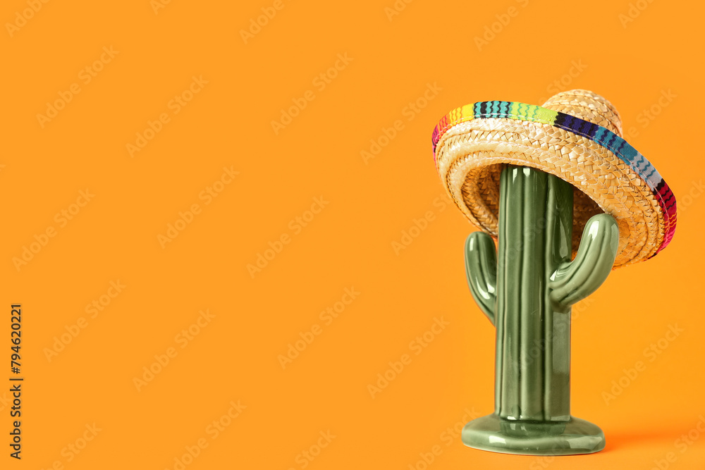 Cactus with Mexican sombrero on orange background. Cinco de Mayo