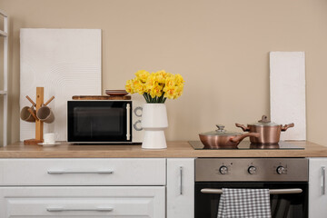 Sticker - Vase with beautiful daffodil flowers on kitchen counter