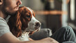 a man sittning in meeting thinking about his welsh springer spaniel dog