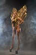 Sensual lady wearing golden carnival costume in studio