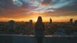 © Sasint - Young adult enjoying a sunset over a new city from an urban rooftop