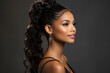 portrait of a beautiful black african american woman with long curly braids and bun. Perfect facial structure. Sharp jaw looking in profile. isolated on dark background