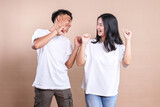 Fototapeta  - Asian man and woman couple wearing white t-shirt for mockup on beige background.