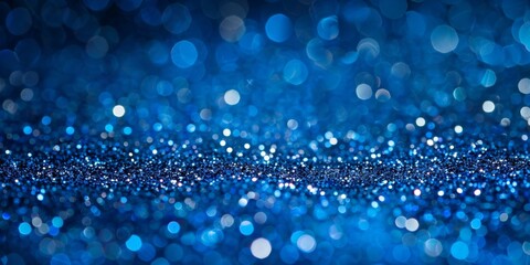 Wall Mural - Abstract blue bokeh background with glittering particles, ideal for festive or celebratory concepts.