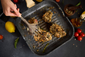 Wall Mural - pieces of Organic Tuna fillet covered with sesame seeds frying on a hot grill pan