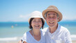 © bephoto - ビーチで微笑む日本人のシニア夫婦