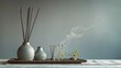 An elegant display of handcrafted ceramic pieces and incense sticks in a minimalist setting