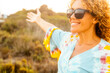 One cheerful happy woman having fun and enjoying outdoor leisure activity alone smiling and enjoying outdoor leisure activity alone wearing sunglasses for sun. People and healthy lifestyle concept