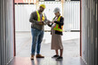 © chachamp - Middle east logistic worker foreman use walkie talkie working with caucasian logistic engineer pregnant woman at container site