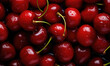 A bunch of red cherries with green stems