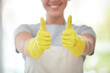 © peopleimages.com - Happy cleaner, hands and thumbs up with gloves for housekeeping, thank you or cleaning service at home. Closeup of person or maid with like emoji, yes sign or ok for review, vote or rating in hygiene