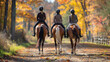 Three individuals are riding horses down a dusty path. The horses are equipped with horse tack including halters, saddles, and bridles for the equestrian activity