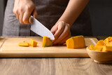 Fototapeta Kosmos - Organic pumpkin cutting on wooden board, Homemade cooking, Food ingredient