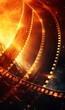 A glowing film reel with a fiery orange abstract backdrop.