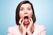 Portrait, wow and surprise of shocked woman with horror, fear or scared in studio isolated on blue background. Face, omg and wtf announcement of model with secret, news or emoji expression for gossip
