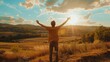 © Roxana - a man standing in a field with his arms raised