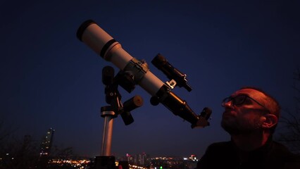 Wall Mural - amateur astronomer looking at the evening skies, observing planets, stars, moon and other celestial 
