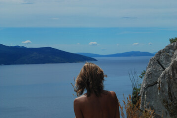 Sticker - the woman observes the splendid lagoon on the island of Cres in Croatia from above