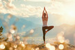 Woman practices yoga on background of mountains and sunrise