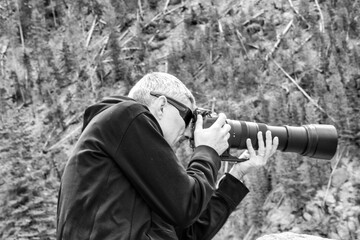 Poster - Photographer with a zoom lens at Yellowstone National Park