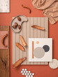 Stylish flat lay composition in orange and beige color palette with textile and paint samples, lamella panels and tiles. Architect and interior designer moodboard. Top view. Copy space.