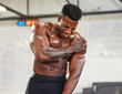 © peopleimages.com - African man, gym and shoulder injury in pain with fitness, muscular and exercise at workout. Bodybuilder, hurt and holding arm for torn muscle, burnout and strain in sports or weightlifting