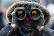 Man looking through binoculars in search