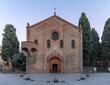 The robust brick facade and arched entrance of the Basilica of Santo Stefano Seven Churches complex, located in Bologna, Italy, display the classic Romanesque style