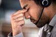 © peopleimages.com - Man, stress and headset as employee at call center with customer or client support and service. Office, crm and advisor or consultant with fatigue, burnout and tired with headache and overtime